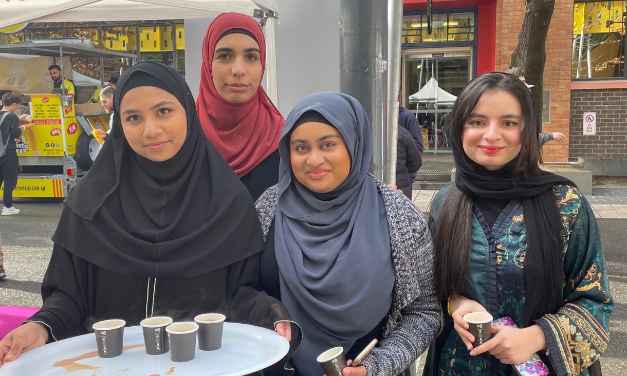 four students at RMIT’s inclusive community on show during Eid-al-Adha celebrations smiling 