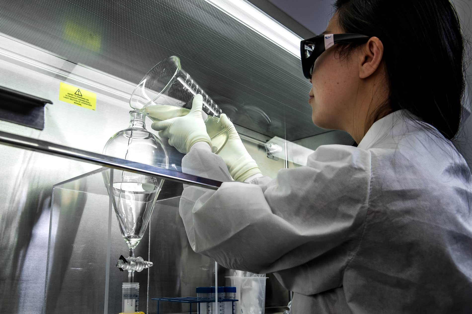 Scientist using chemistry equipment in lab