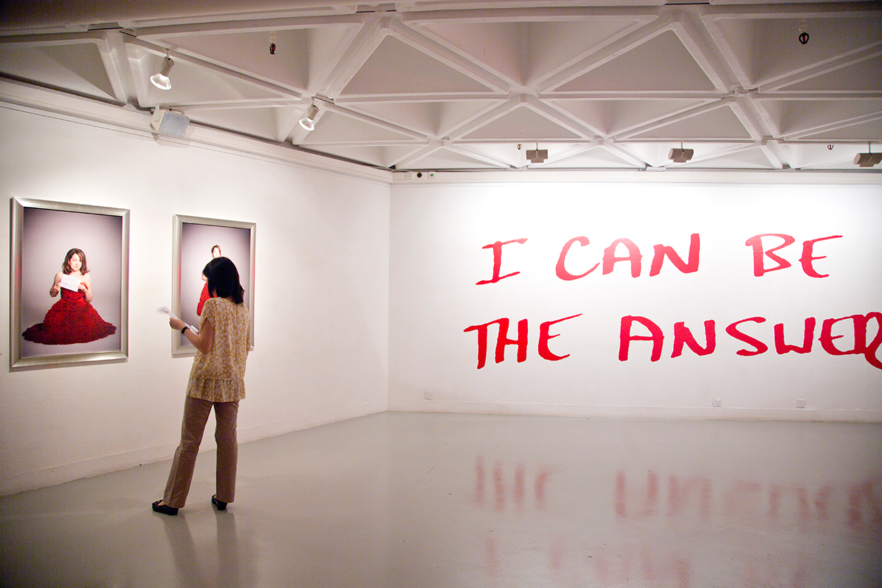 Image of a person looking at a painting in a gallery