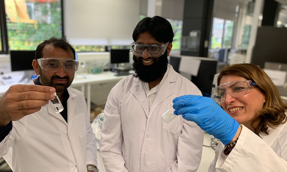 Dr Nasir Mahmood, PhD candidate Muhammad Haris and Professor Nicky Eshtiaghi (left to right) with a sample of water with microplastics and a vial of clean water following its treatment with their innovation. Credit: RMIT University