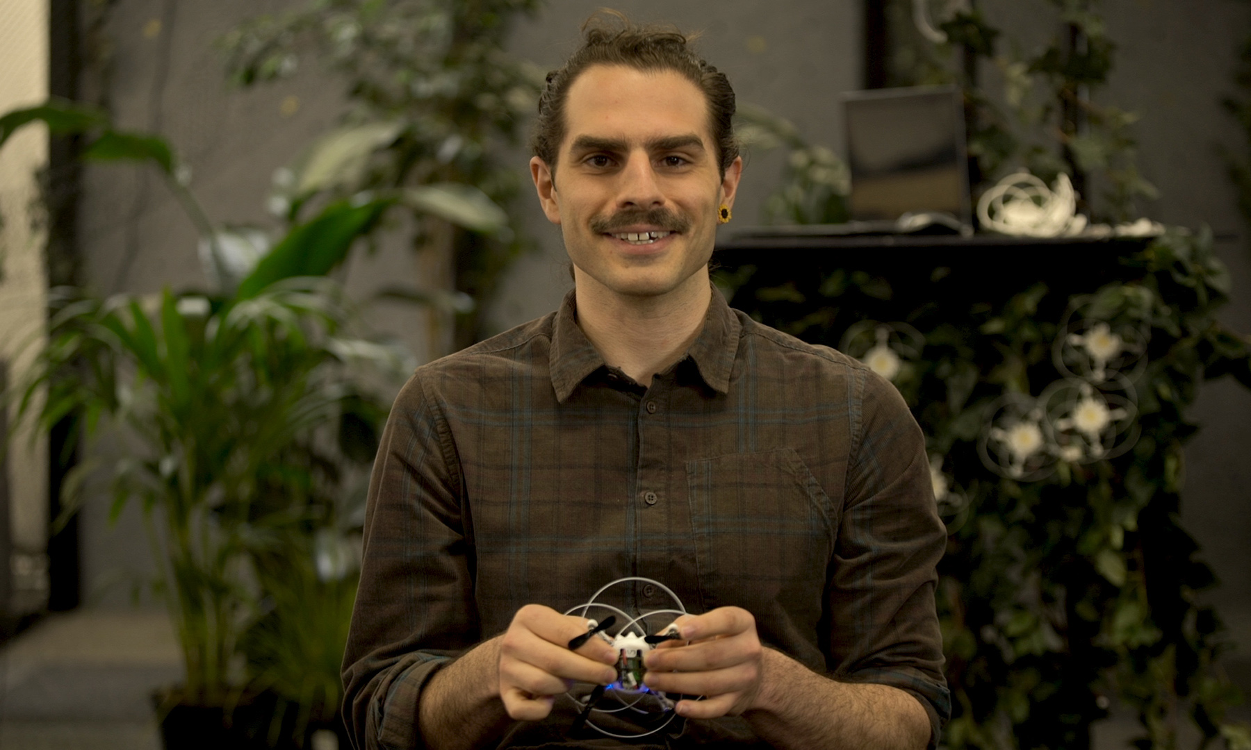 Joe La Delfa talks to camera, holding one of this drones.